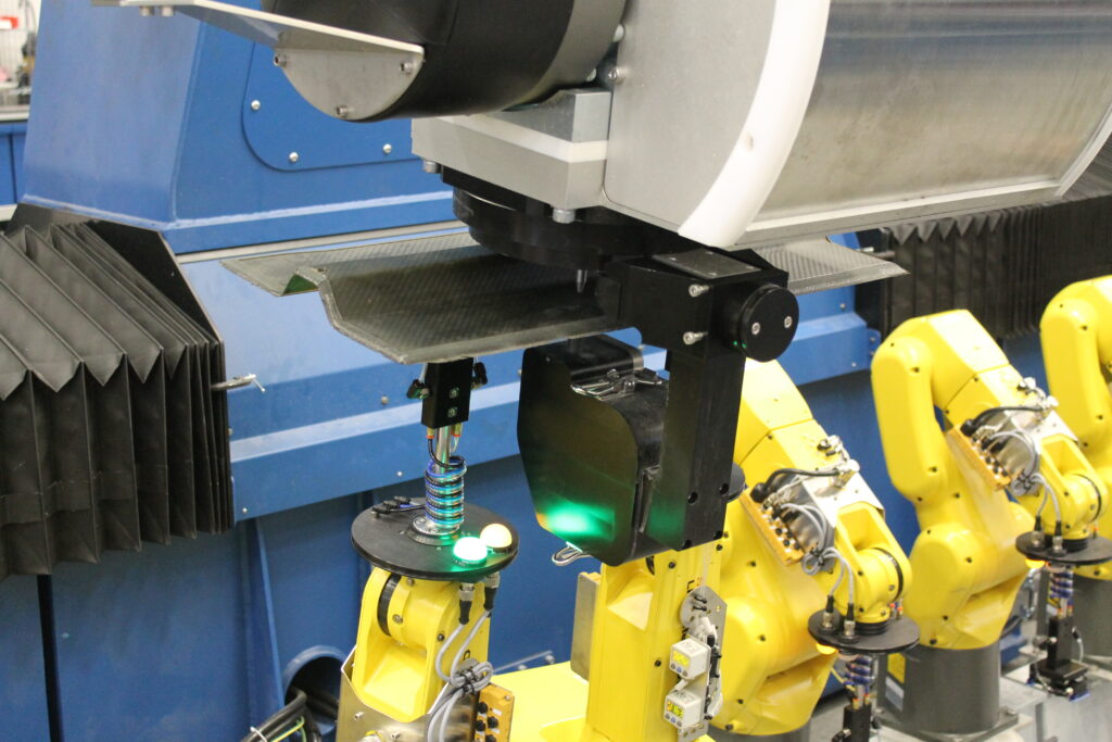 waterjet cutting of composite part in robotic fixture