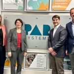 Senator Amy Klobuchar standing with PAR Systems leaders